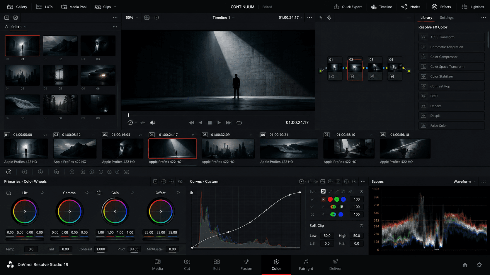 A color-grading suite with primaries wheels and a waveform scope over a graded frame